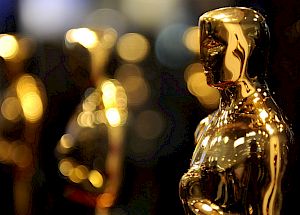 Golden statuettes in focus with blurred ones in the background.