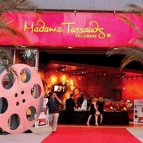 Entrance to Madame Tussauds Hollywood with large film reels and a red carpet.
